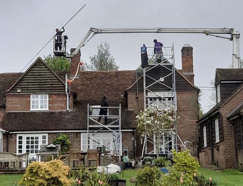 The Roof Moss Cleaners using cherry picker and scaffolding to clean roof safely and professionally in Olney, Buckinghamshire